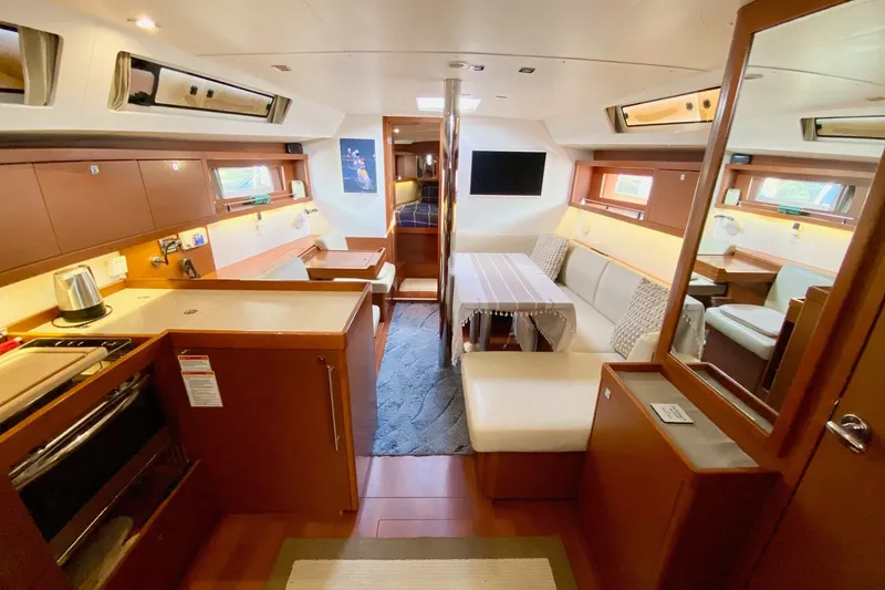 Slide: The Image of Interior of 2016 Beneteau Oceanis 41 yacht, featuring modern kitchen and cozy seating area. - 26