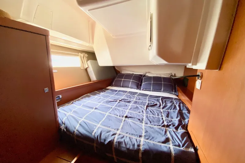 Slide: The Image of Cozy cabin interior of 2016 Beneteau Oceanis 41 sailboat with plaid bedding. - 48