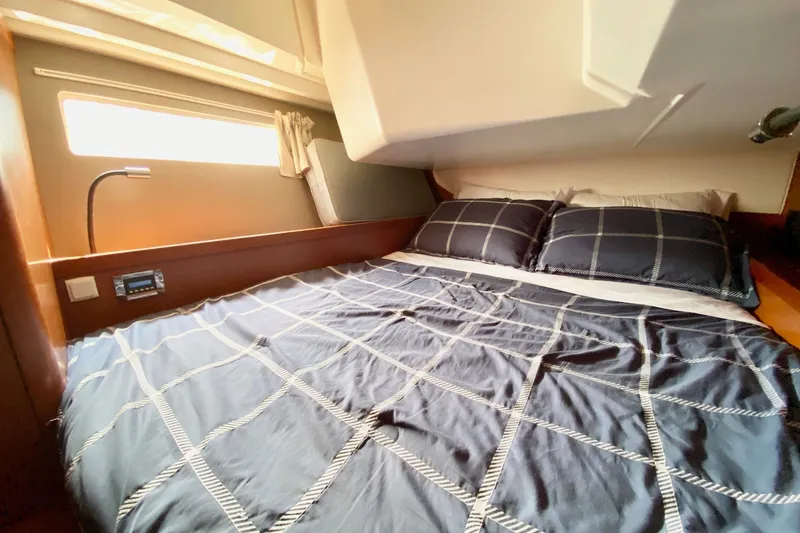 Slide: The Image of Cozy cabin interior of 2016 Beneteau Oceanis 41 sailboat with plaid bedding. - 49