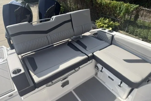 Slide: The Image of 2027 Monterey Elite 27 OB boat interior with gray seating and dual outboard motors. - 15