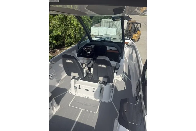 Slide: The Image of 2027 Monterey Elite 27 OB boat interior with dual seats and modern dashboard. - 19