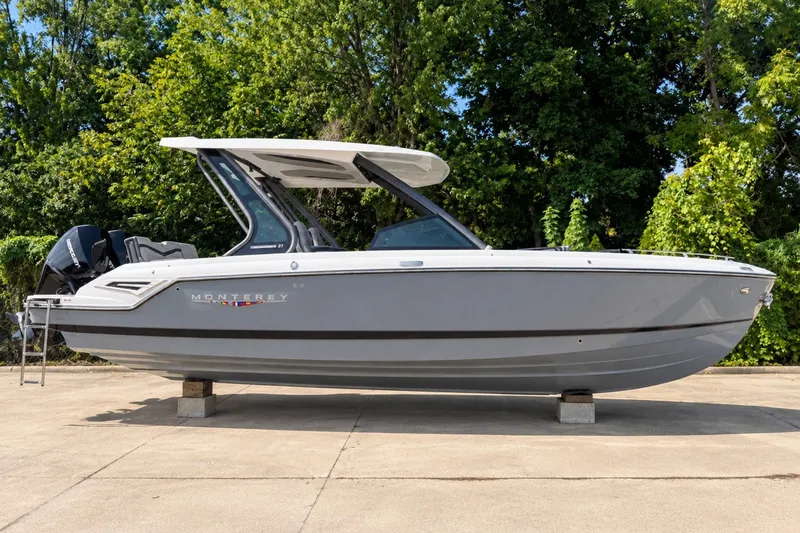 Slide: The Image of 2027 Monterey Elite 27 OB boat on display, sleek design, parked outdoors. - 1