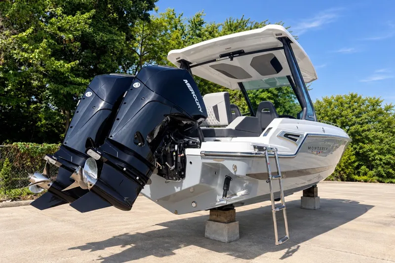 Slide: The Image of 2027 Monterey Elite 27 OB boat with dual outboard engines on display. - 2