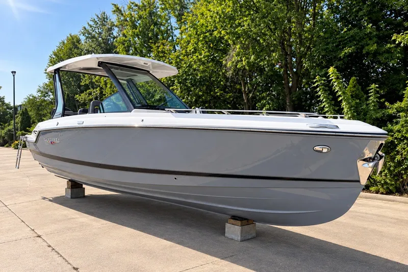 The Image of 2027 Monterey Elite 27 OB boat displayed outdoors on a sunny day. - 0