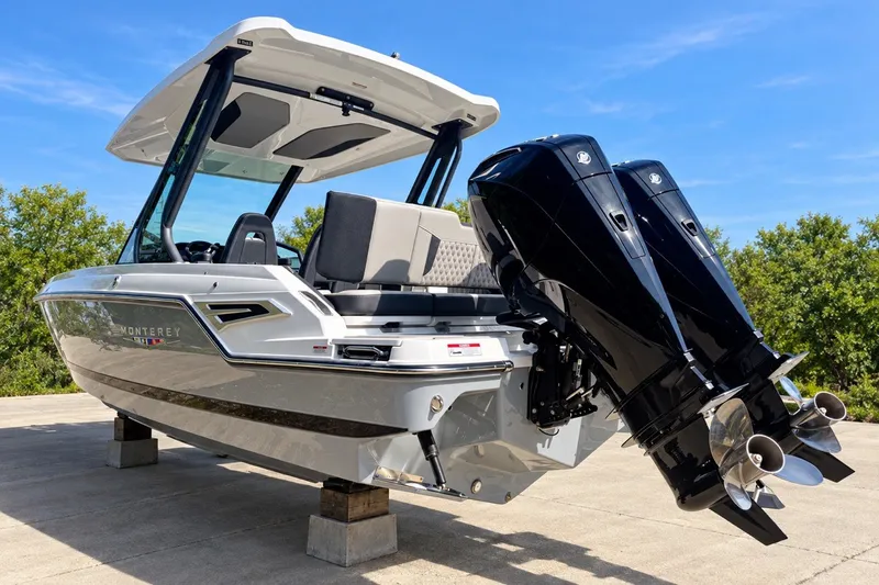 Slide: The Image of 2027 Monterey Elite 27 OB boat with dual outboard engines on display. - 3