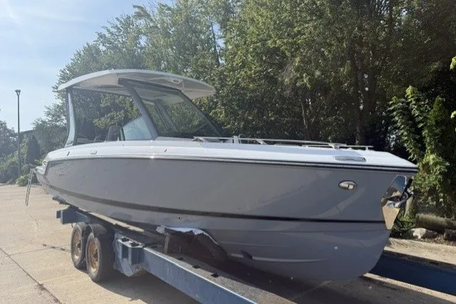 The Image of 2027 Monterey Elite 27 OB boat on trailer, parked outdoors. - 0
