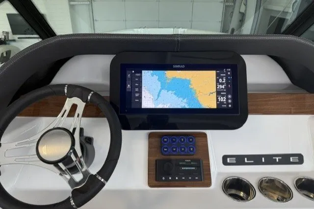 Slide: The Image of Dashboard of 2027 Monterey Elite 23 SD boat with navigation display and steering wheel. - 19