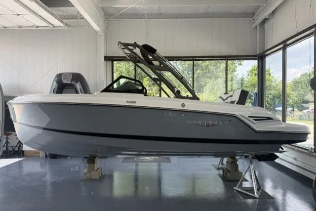 Slide: The Image of 2027 Monterey Elite 23 SD boat displayed indoors on stands. - 16