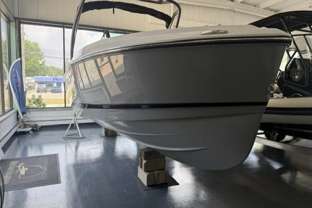 Slide: The Image of 2027 Monterey Elite 23 SD boat displayed indoors on blocks. - 26