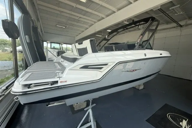Slide: The Image of 2027 Monterey Elite 23 SD boat displayed in a showroom, showcasing sleek design and modern features. - 17