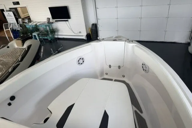 Slide: The Image of 2027 Monterey Elite 23 SD boat interior with white seating and speakers. - 34