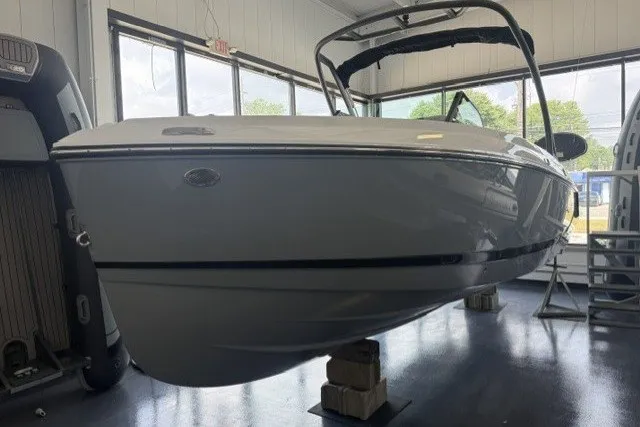 Slide: The Image of 2027 Monterey Elite 23 SD boat displayed indoors on blocks. - 27