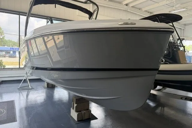 Slide: The Image of 2027 Monterey Elite 23 SD boat displayed indoors on blocks. - 25