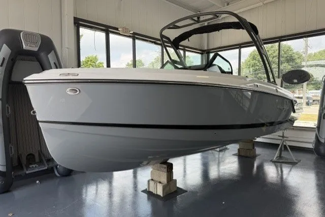 Slide: The Image of 2027 Monterey Elite 23 SD boat displayed indoors on blocks. - 15