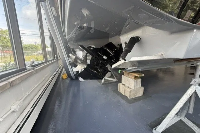 Slide: The Image of 2027 Monterey Elite 23 SD boat on blocks in a showroom. - 24