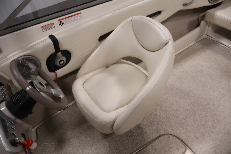 Slide: The Image of 2008 Maxum 1900 SR3 boat interior with beige seating and steering wheel. - 22