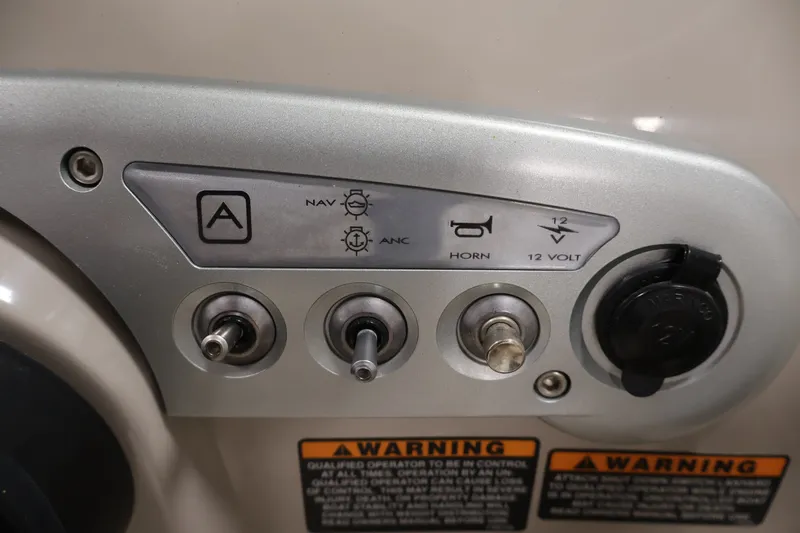 Slide: The Image of Control panel of a 2008 Maxum 1900 SR3 boat with switches and warning labels. - 21