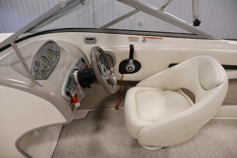 Slide: The Image of 2008 Maxum 1900 SR3 boat interior with steering wheel and dashboard controls. - 16