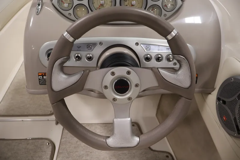 Slide: The Image of Steering wheel and dashboard of 2008 Maxum 1900 SR3 boat, featuring gauges and controls. - 18