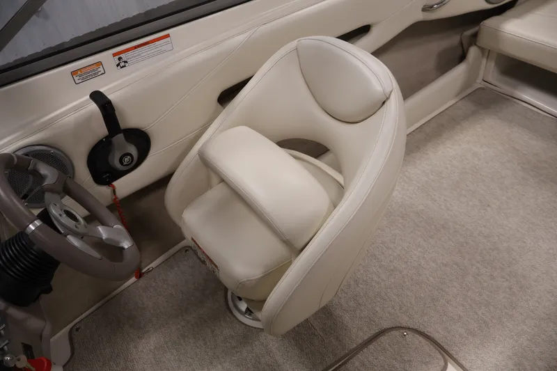 Slide: The Image of 2008 Maxum 1900 SR3 boat interior with beige seating and steering wheel. - 23