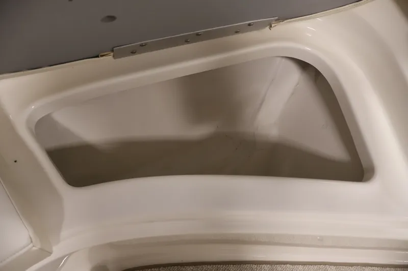 Slide: The Image of Storage compartment of a 2008 Maxum 1900 SR3 boat, featuring a clean, white interior. - 15