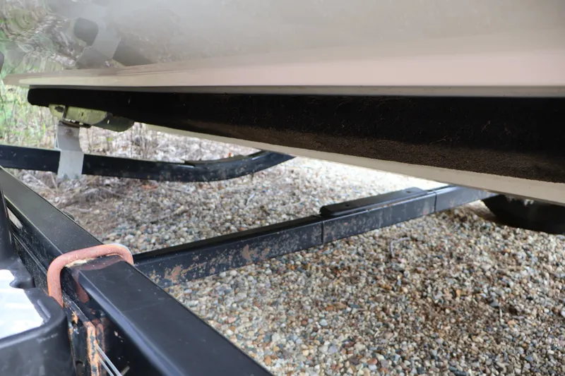 Slide: The Image of 2008 Maxum 1900 SR3 boat on trailer, showing underside and gravel ground. - 45