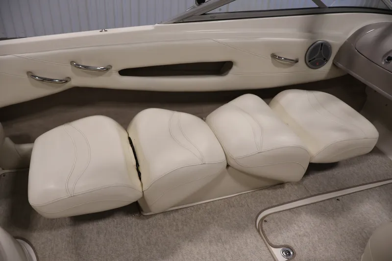 Slide: The Image of 2008 Maxum 1900 SR3 boat interior with white cushioned seating and speaker. - 30