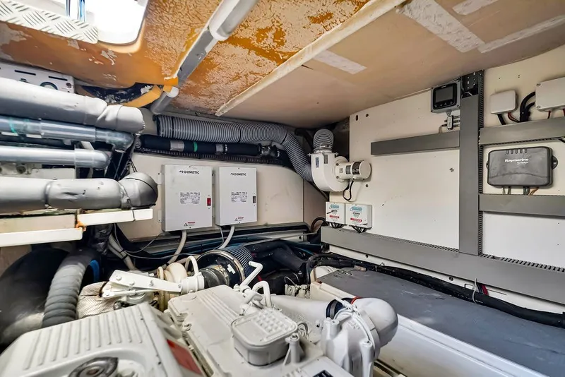 Slide: The Image of Engine room of a 2013 Prestige 550 yacht with visible equipment and wiring. - 85