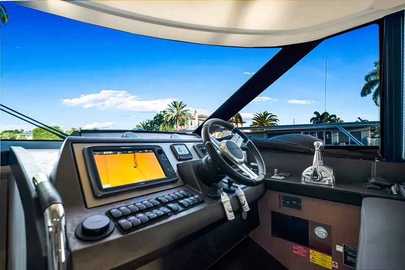 Slide: The Image of Cockpit of 2013 Prestige 550 yacht with navigation controls and scenic view. - 54
