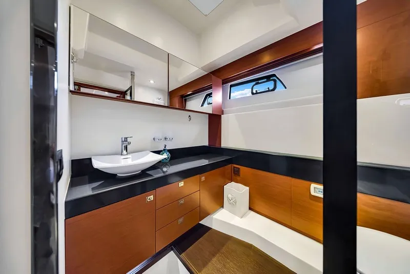 Slide: The Image of Luxurious bathroom interior of 2013 Prestige 550 yacht with modern fixtures and wood accents. - 67