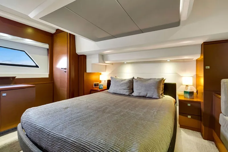 Slide: The Image of Luxurious bedroom interior of a 2013 Prestige 550 yacht with modern furnishings. - 62