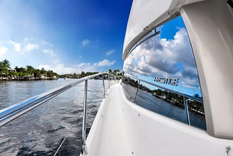 Slide: The Image of 2013 Prestige 550 yacht cruising on a sunny day with clear blue skies. - 31