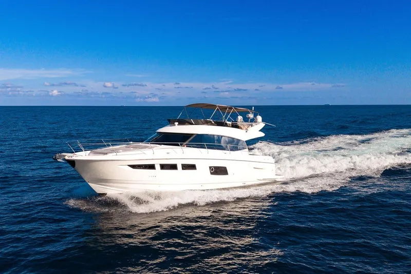 Slide: The Image of Luxury 2013 Prestige 550 yacht cruising on open sea under clear blue sky. - 16