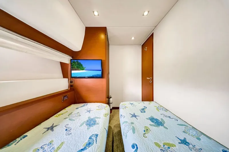 Slide: The Image of Luxurious cabin interior of 2013 Prestige 550 yacht with twin beds and TV. - 74