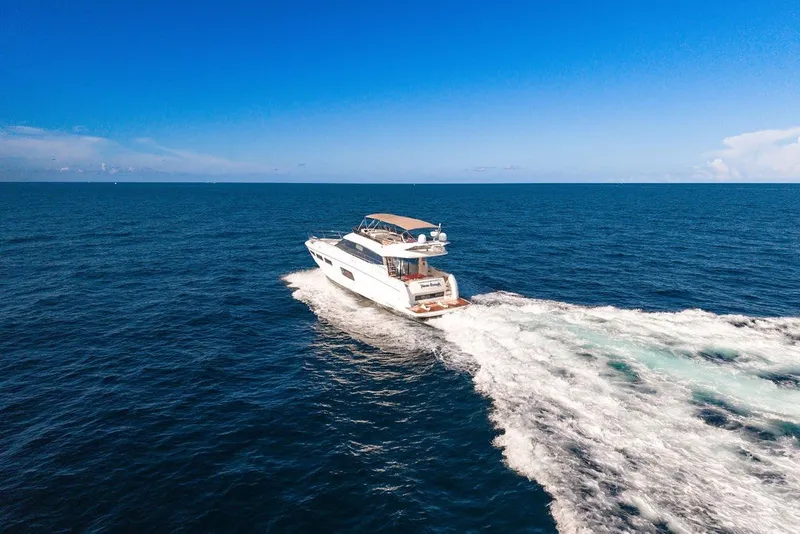 Slide: The Image of Luxury 2013 Prestige 550 yacht cruising on open ocean under clear blue sky. - 18