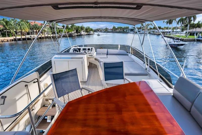 Slide: The Image of Luxurious 2013 Prestige 550 yacht interior with seating, table, and scenic waterfront view. - 37