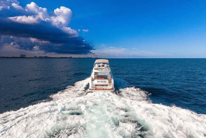 Slide: The Image of Prestige 550 yacht cruising on open sea under clear blue sky, 2013 model. - 19