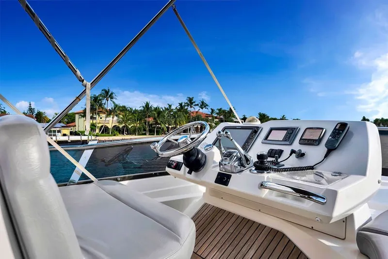 Slide: The Image of Cockpit of 2013 Prestige 550 yacht with steering wheel and navigation controls. - 40