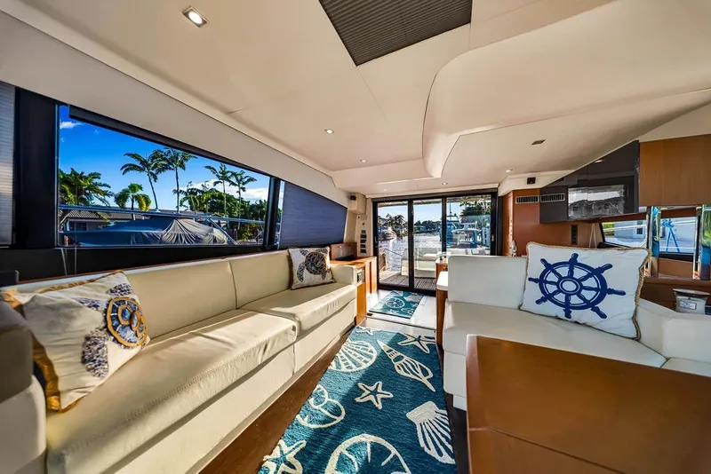 Slide: The Image of Luxurious interior of 2013 Prestige 550 yacht with nautical-themed decor and large windows. - 50