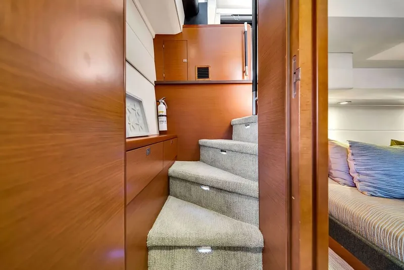 Slide: The Image of Interior of 2013 Prestige 550 yacht with carpeted stairs and wooden paneling. - 55