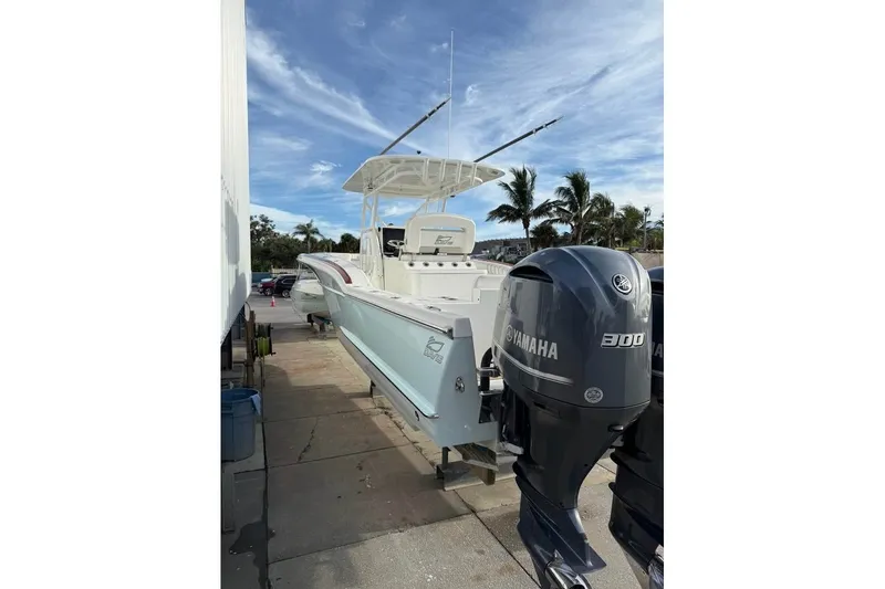 Slide: The Image of 2018 Buddy Davis boat with Yamaha 300 engines, docked under a clear blue sky. - 7