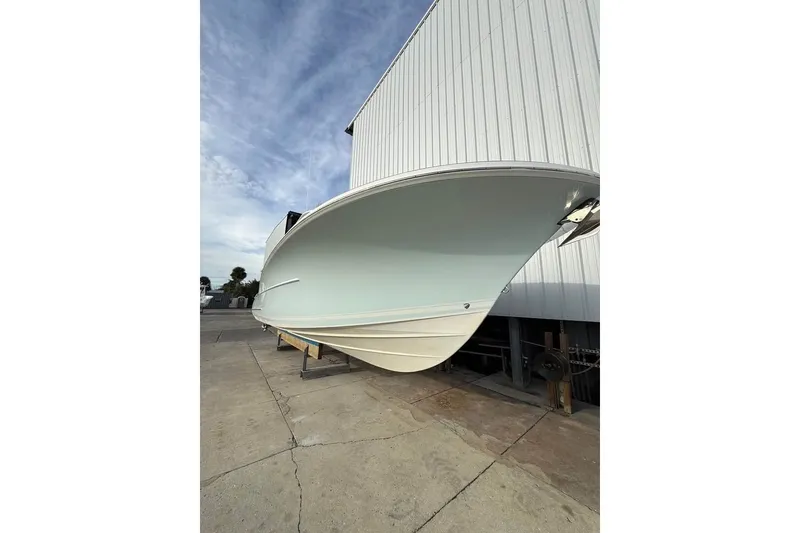Slide: The Image of 2018 Buddy Davis boat hull in dry dock, showcasing sleek design and craftsmanship. - 5