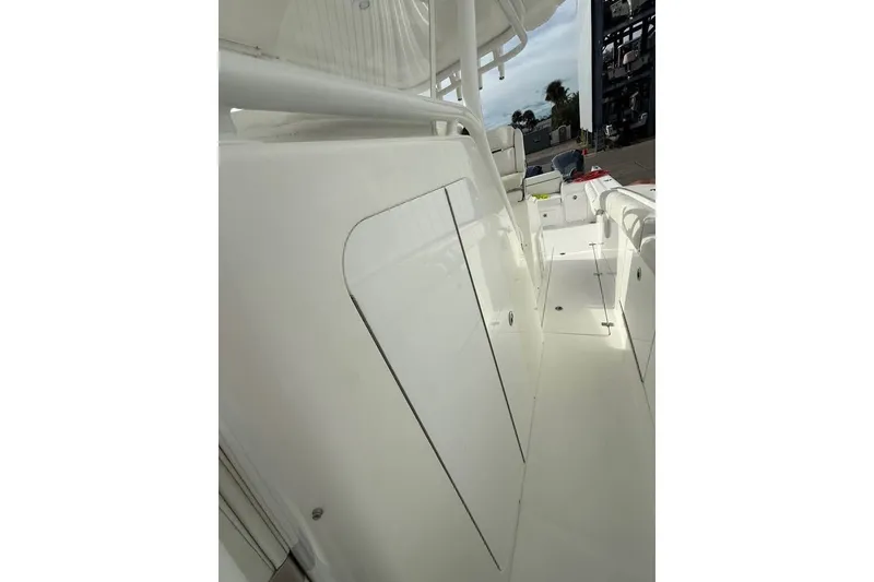 Slide: The Image of 2018 Buddy Davis boat deck with sleek white finish and storage compartments. - 4