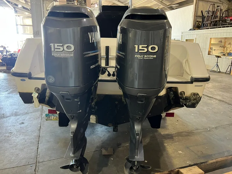 Slide: The Image of Two Yamaha 150 HP outboard engines on an Edgewater 245CC boat in a storage facility. - 3