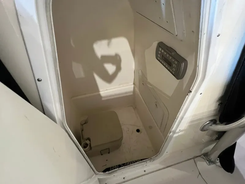 Slide: The Image of Interior view of a boat cabin with a portable toilet and a control panel on the wall. - 8