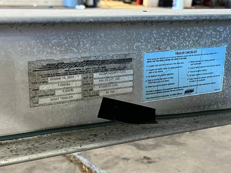 Slide: The Image of A boat trailer with a label displaying technical details and a checklist. - 12