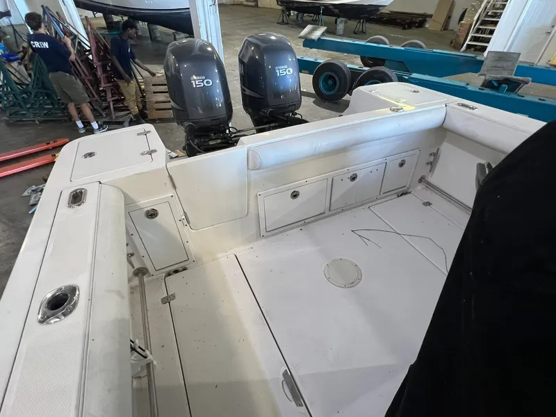 Slide: The Image of The image shows the cockpit of a 2006 Edgewater 245CC boat with two outboard engines. - 11
