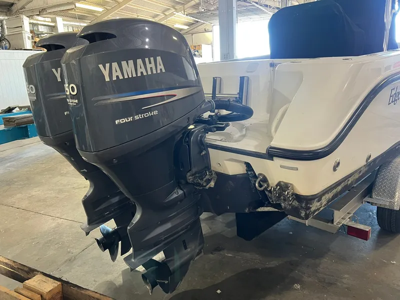 Slide: The Image of Two Yamaha outboard motors on an Edgewater 245CC boat indoors. - 2