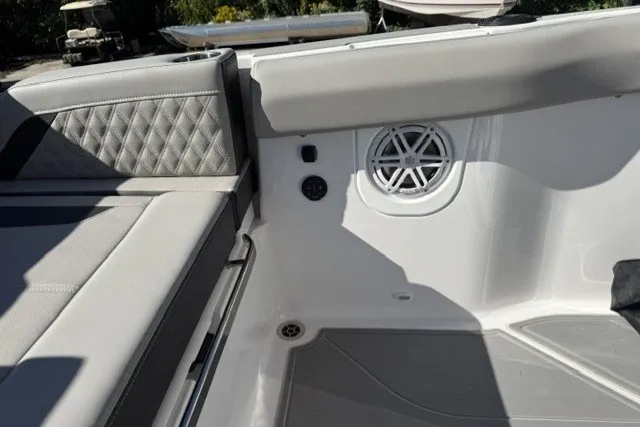 Slide: The Image of Interior of 2027 Monterey Elite 30 OB boat with gray seating and speaker system. - 13