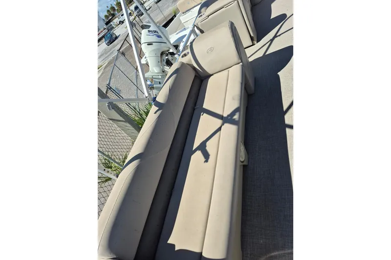 Slide: The Image of 2021 Avalon VLS 2080 QL boat interior with beige seating and Suzuki outboard motor. - 10